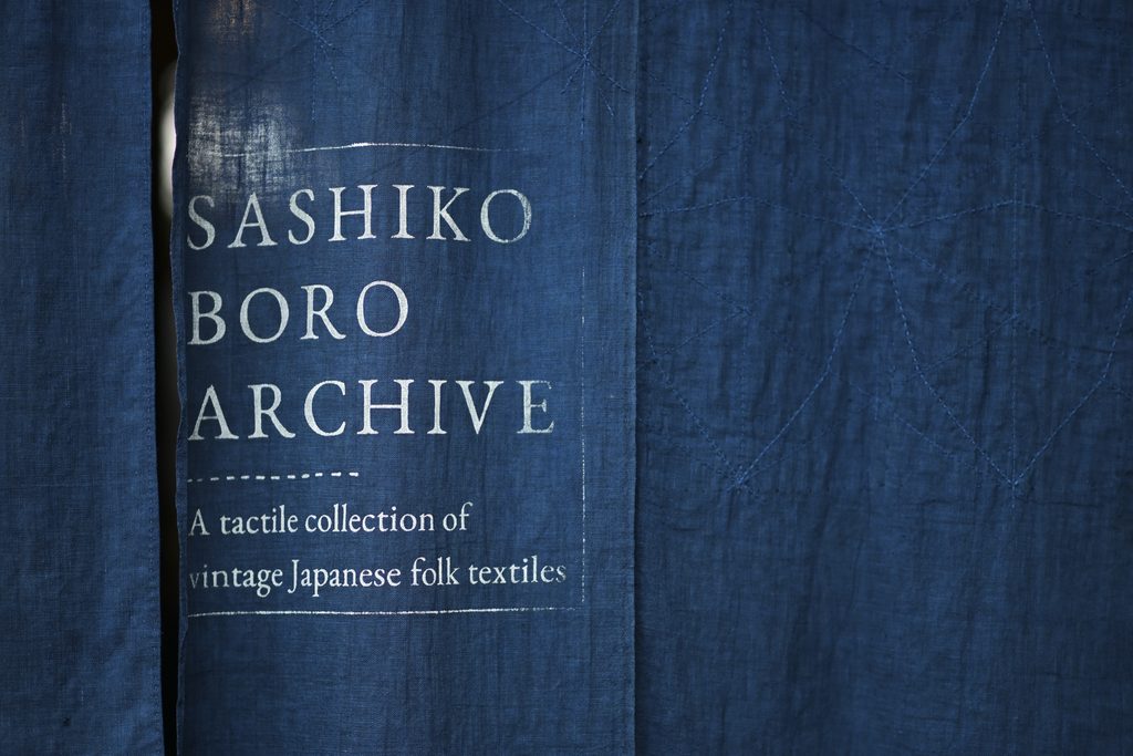 SASHIKO BORO ARCHIVE signage on indigo dyed textile