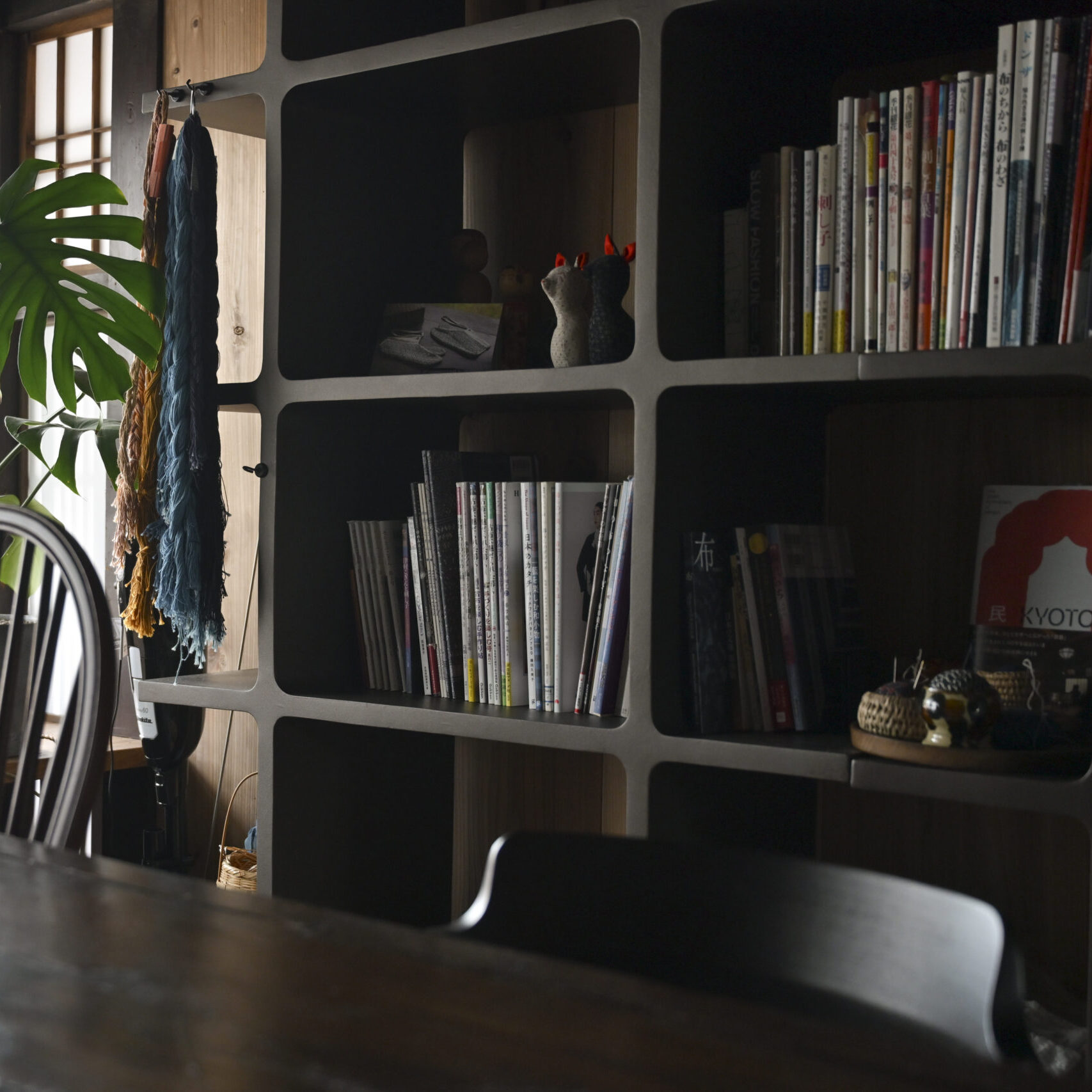 Shelves of books in the SASHIKO.LAB atelier